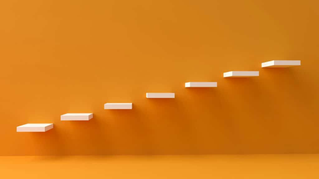 An orange wall with steps attached to it, going up in sequential levels.